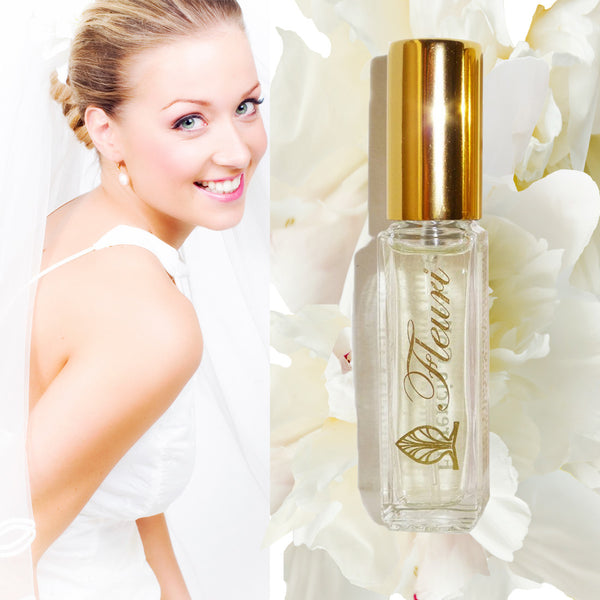 Fleuri Perfume bottle with a gold top. Woman in a wedding dress looking over her shoulder.