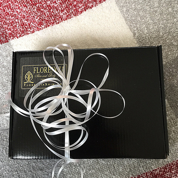 Gift Wrap black box with multiple white ribbons.
